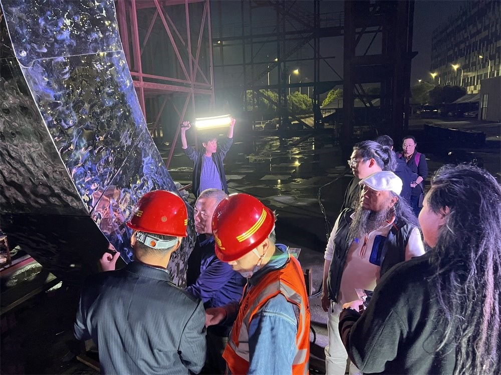 林崗（右二）和團(tuán)隊(duì)查看主火炬制作進(jìn)度。受訪者供圖