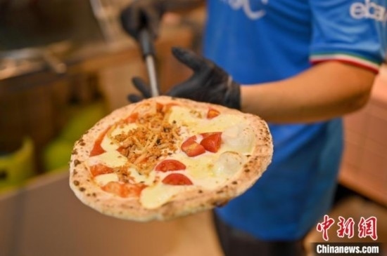 近日，韋榮耀展示他制作的“老友味”披薩。 俞靖 攝