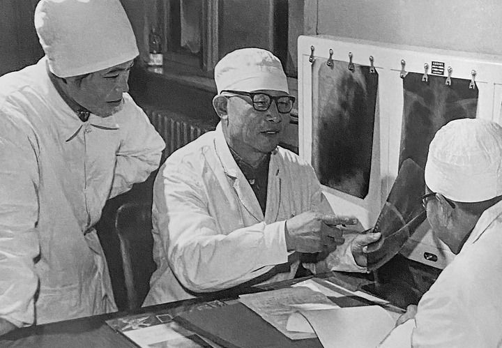 1980年1月16日，中日友好醫(yī)院首任院長辛育齡（中）在內蒙古結核病院與胸外科醫(yī)師討論病例（翻拍照片）。 新華社發(fā)
