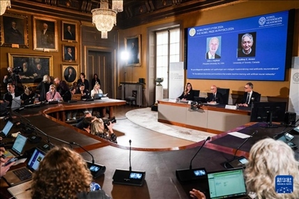 10月8日，在瑞典斯德哥爾摩舉行的2024年諾貝爾物理學(xué)獎公布現(xiàn)場，屏幕顯示獎項(xiàng)得主美國普林斯頓大學(xué)的約翰·霍普菲爾德和加拿大多倫多大學(xué)的杰弗里·欣頓。新華社記者 彭子洋 攝