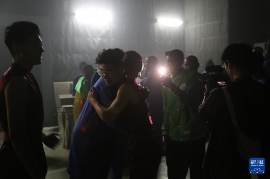 4月10日，在塞內(nèi)加爾首都達(dá)喀爾的國家大劇院，中央音樂學(xué)院進(jìn)擊打擊樂團(tuán)成員與塞內(nèi)加爾杜杜·恩迪亞耶·羅斯打擊樂團(tuán)成員在演出后臺(tái)擁抱。新華社記者 司源 攝